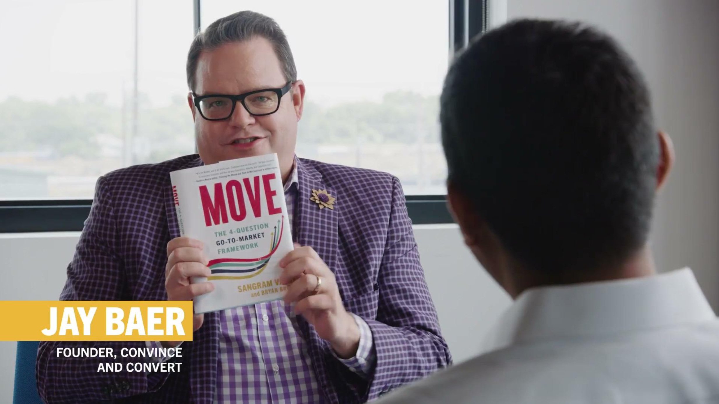 Jay Baer holding a copy of MOVE: The 4-Question Go-to-Market Framework Book